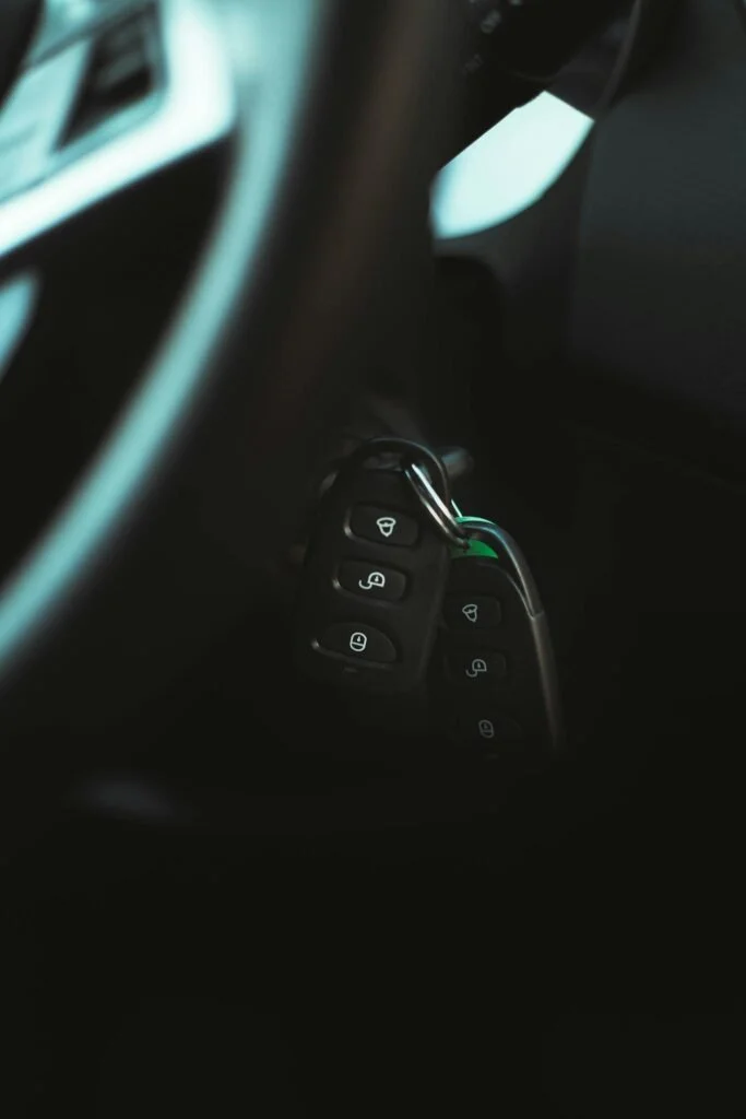 Close-up photo of a car key in the ignition, highlighting modern vehicle interior design.